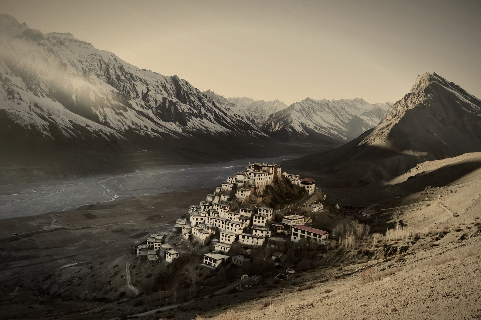 A monastery village on a ridge in the Spiti Valley, with mountains behind
